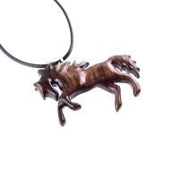 A wooden horse pendant necklace with a black cord. The horse is brown and has a detailed mane and tail.