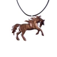 A wooden horse pendant necklace with a black cord. The horse is brown and has a detailed mane and tail.