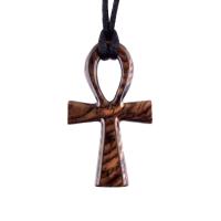 A wooden ankh pendant necklace with a black satin cord. The ankh is reddish-brown with a wood grain pattern.