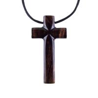 A dark brown wooden cross pendant hanging on a black cord. It has a glossy smooth finish with intricate wood grain.