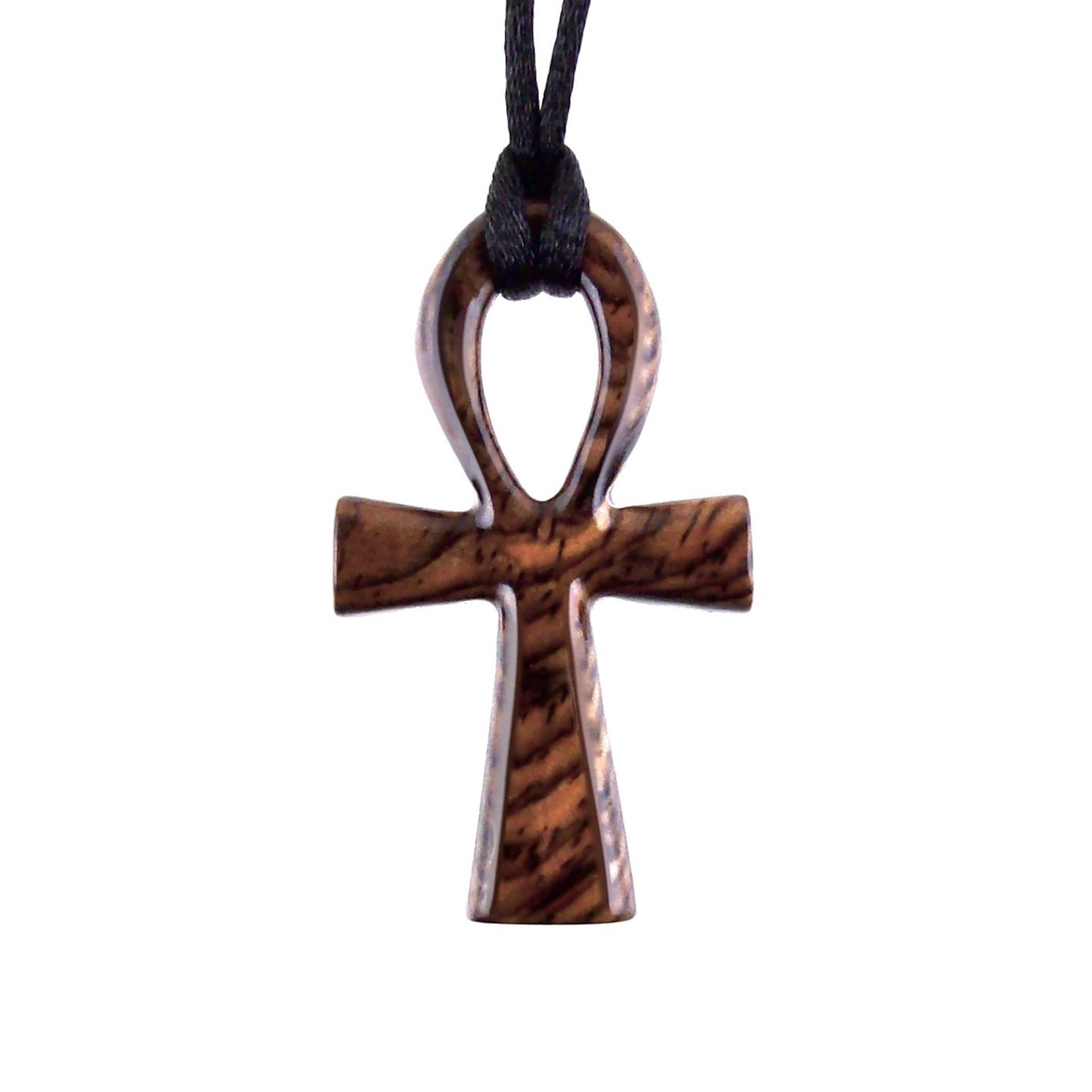 A wooden ankh pendant necklace with a black satin cord. The ankh is reddish-brown with a wood grain pattern.