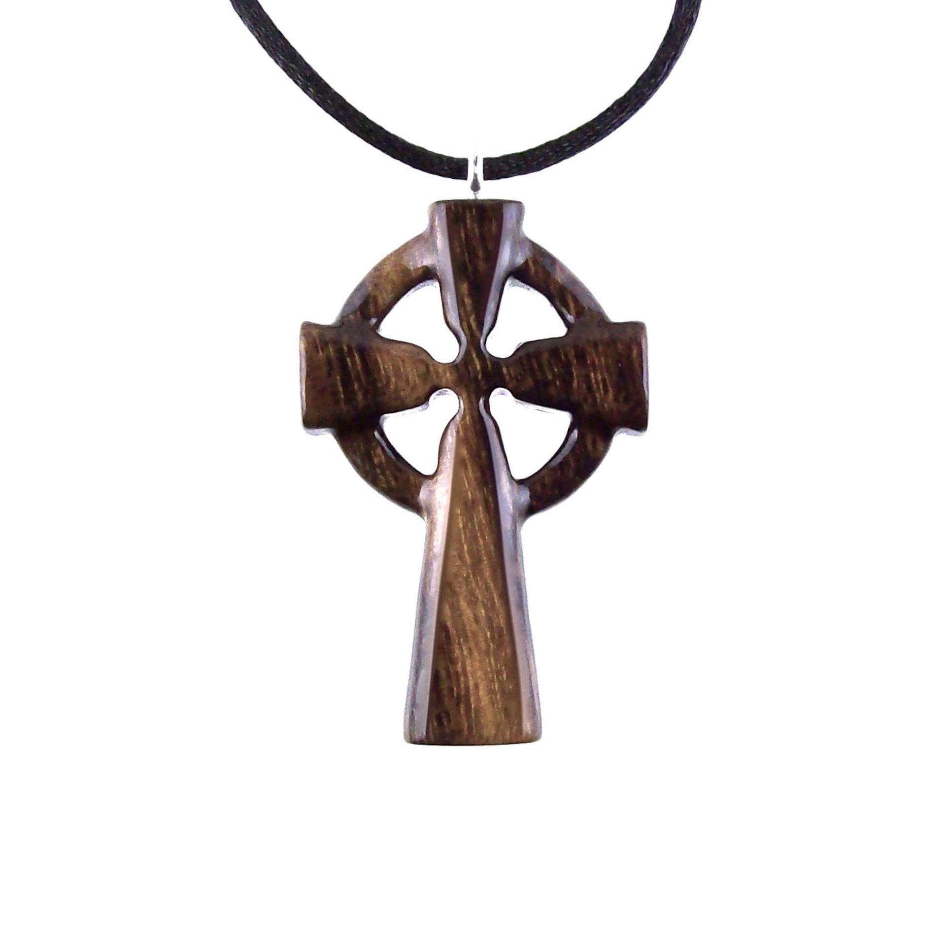 A brown wooden celtic cross pendant with black cord with glossy finish.
