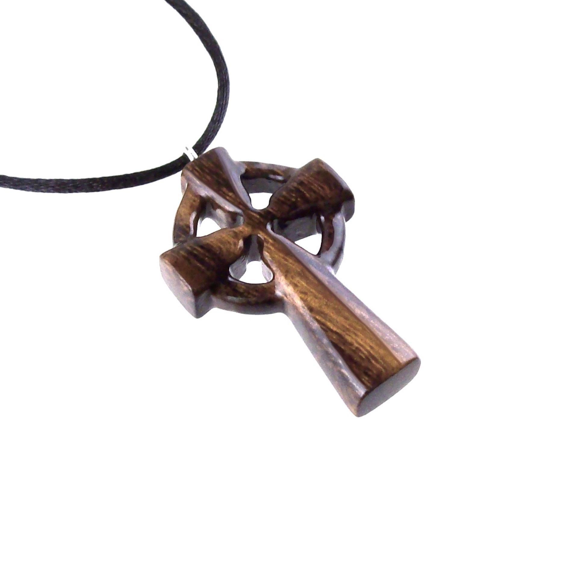 A brown wooden celtic cross pendant with black cord with glossy finish.