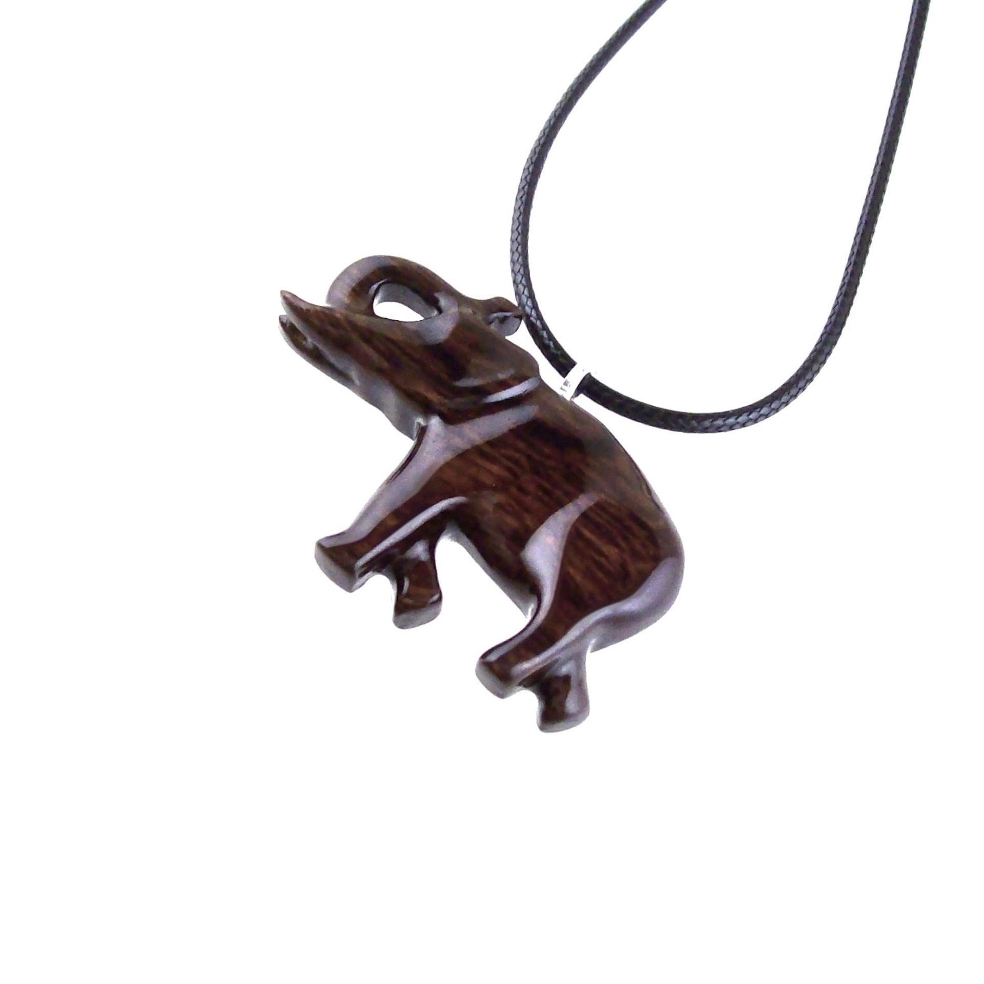 A dark brown wooden elephant pendant necklace with a black cord.